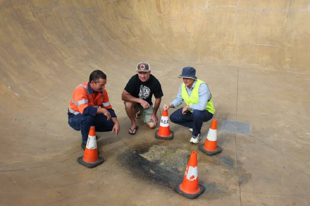 DAMAGED: Bar Beach Skateboard Club's Scott Mckenzie and John Bogaerts inspecting the damage on Monday with Newcastle City Council's projects coordinator Rod Maughan. Picture: Newcastle City Council.