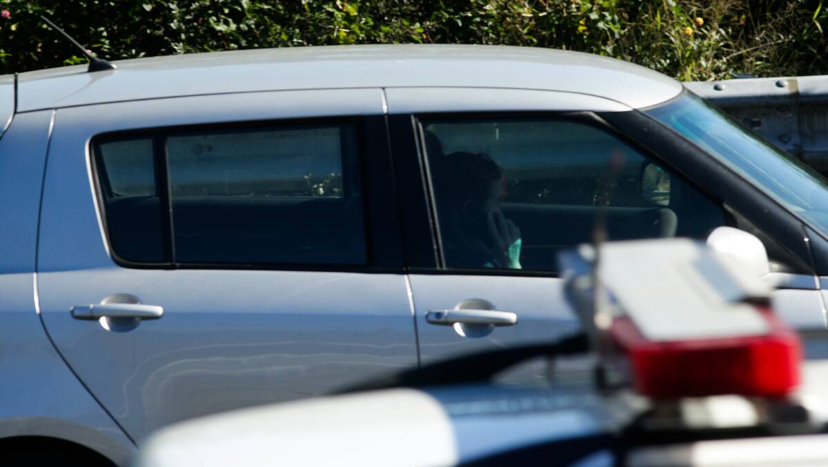BUSTED: A motorist is captured on camera using their phone while driving during the Newcastle Herald's roadside survey last month.