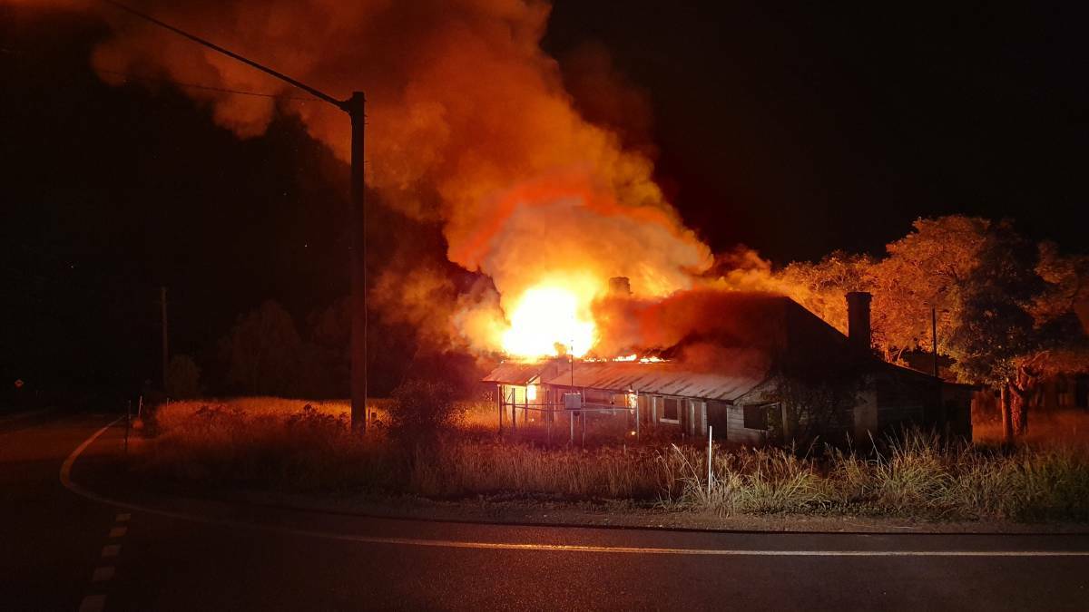 FLAMES: The heritage-listed building Ravensworth Public School House went up in flames on Saturday evening. 