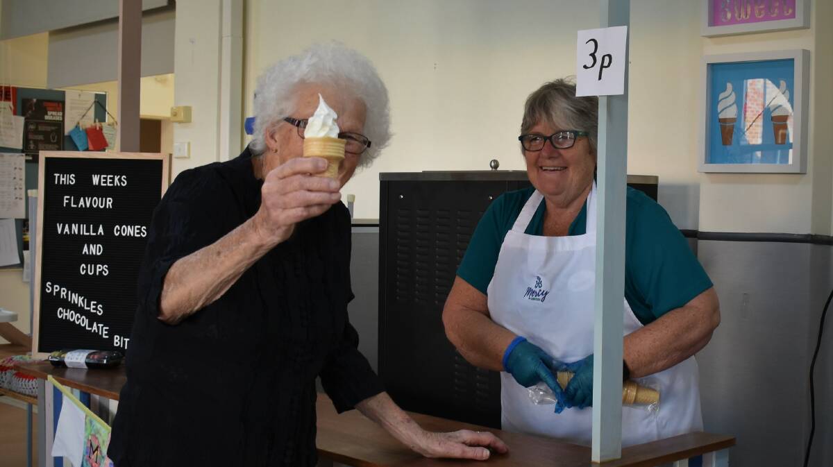 DELICIOUS: Resident Dawn Eslick was the first to officially try out the McMercy Ice Creamery with help from lifestyle coordinator Jenny Yates. 