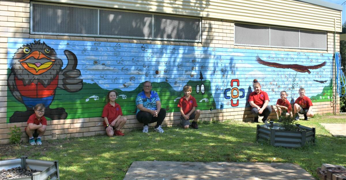 NEW MURAL: Aunty Pauline and students in front of the brand new mural. 