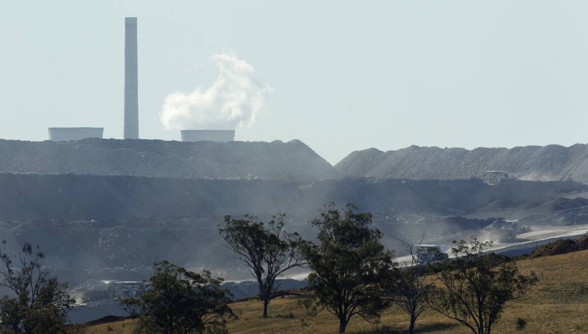 Emissions: Bayswater power station in the background of an Upper Hunter open cut coal mine. Doctors for the Environment say the health costs of power station emissions should be prioritised.