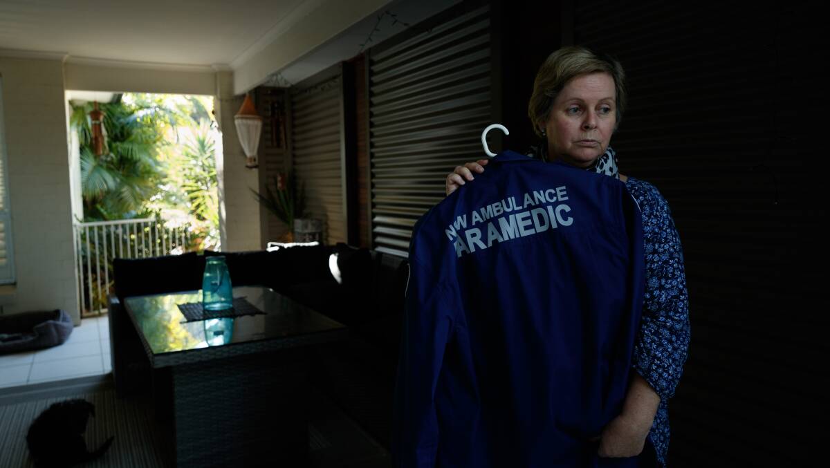 Devastated: Sharon Jenkins with one of her late husband Tony's paramedic uniforms. The devastated family wants a public coronial inquiry into his suicide. Picture: Max Mason-Hubers.