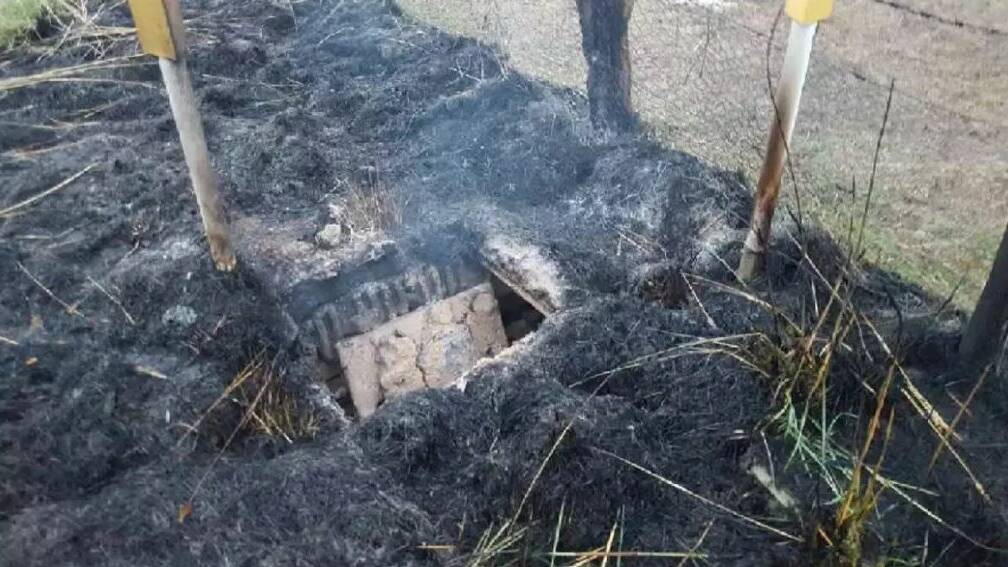 Fire damage at the Telstra cable pit east of Orange. Picture: SMH
