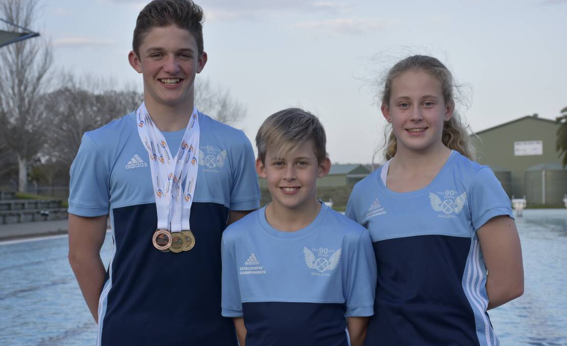 STATE SUCCESS: Moody with the Gray siblings who all competed at the same meet.