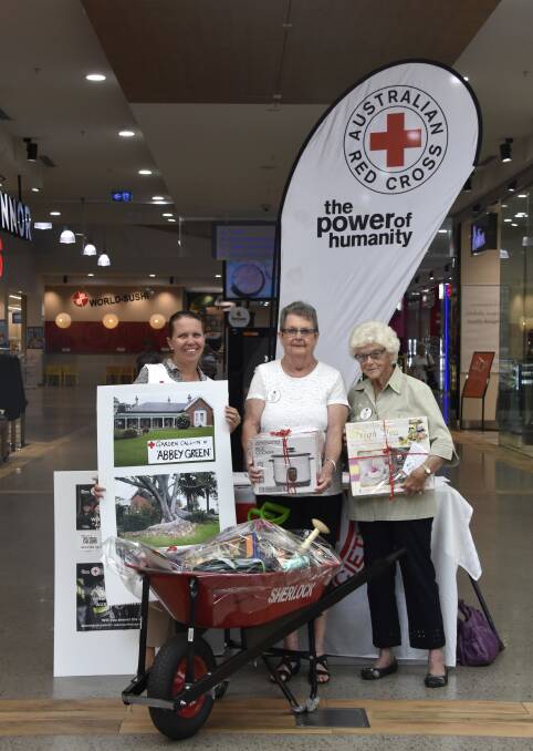 DEDICATED: Singleton Red Cross Patron, Di Sneddon ,and current members selling raffle tickets at the mall.