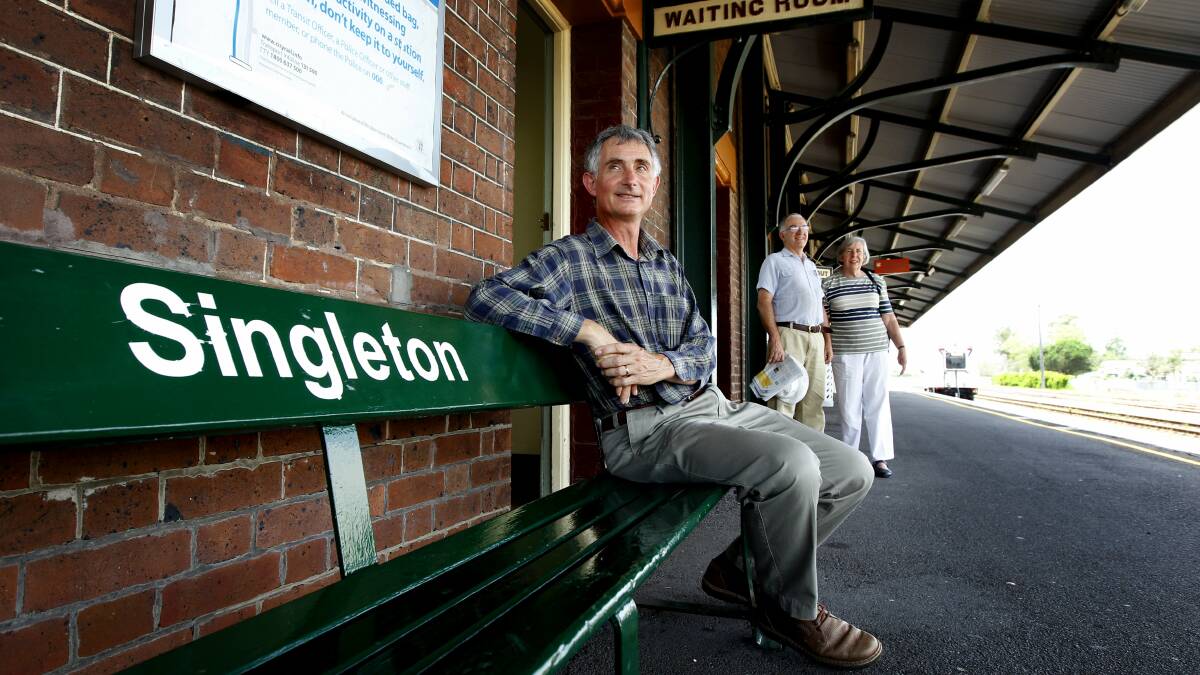 TWO MORE TRAINS: Singleton group members Martin Fallding with Phillip and Anne Boyd at Singleton train station in 2015. Photo by Dean Osland.