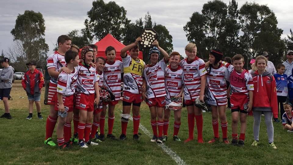 U11's: The boys proudly hoisting up the shield.