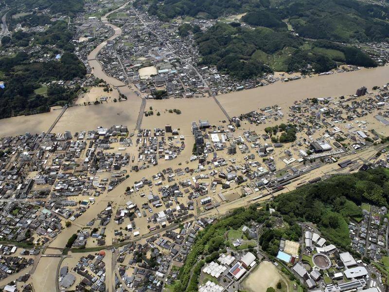 Southern Japan has been hit by flooding and mudslides, leaving more than a dozen missing.