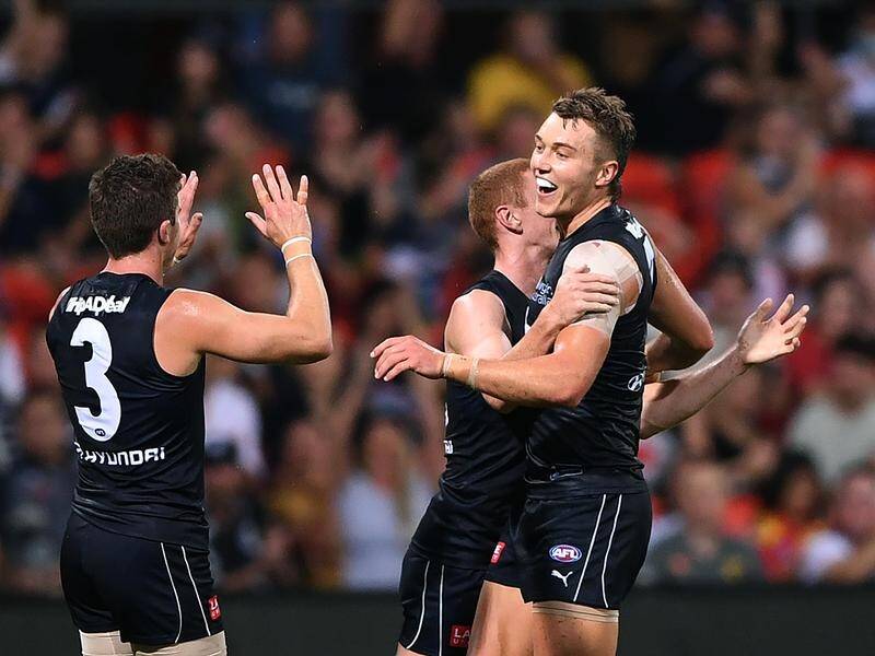 Patrick Cripps (r) celebrates kicking a goal during Carlton's 11-point AFL win over Gold Coast.