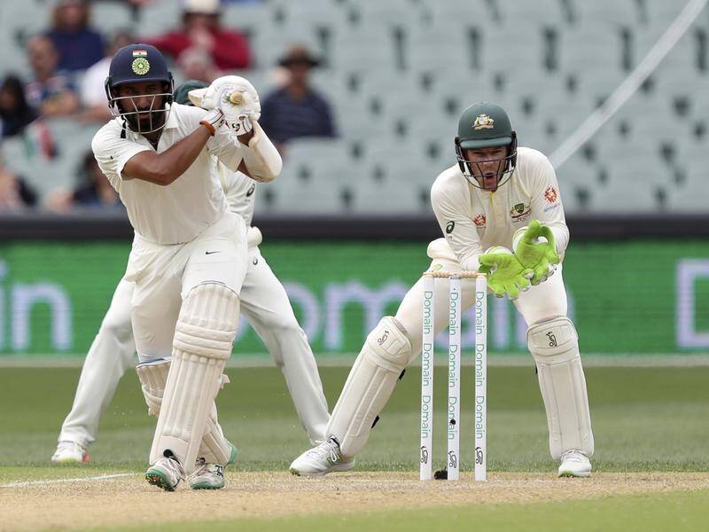 A DRS review has saved India's Cheteshwar Pujara on 17 on day three of the first Test in Adelaide.