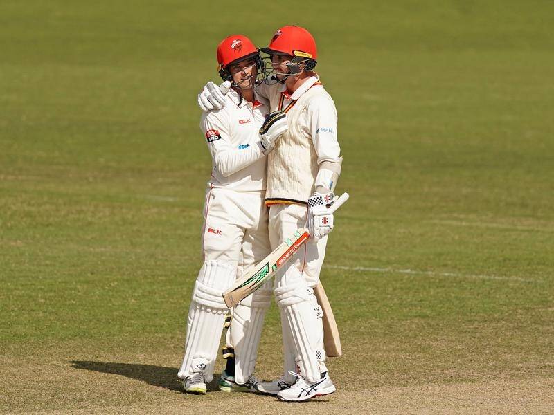 Alex Carey (L) and Tom Cooper (R) hit tons before South Australia's match with Victoria degenerated.