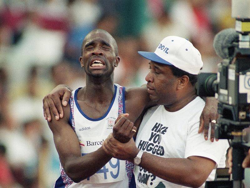 British runner Derek Redmond is helped from the Olympic track by his father Jim at Barcelona '92. (AP PHOTO)