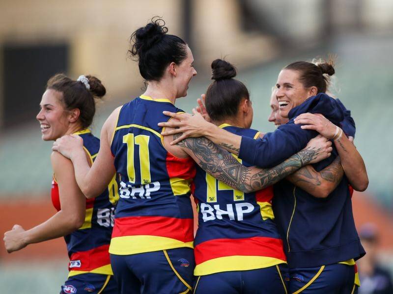 Crows celebrate reaching the AFLW grand final, but Chelsea Randall (r) may miss the showpiece.