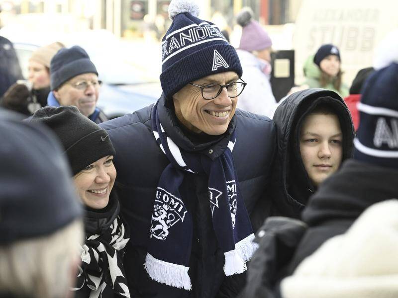 Finland's presidential candidate Alexander Stubb poses with fans as he campaigns in Vantaa. (AP PHOTO)