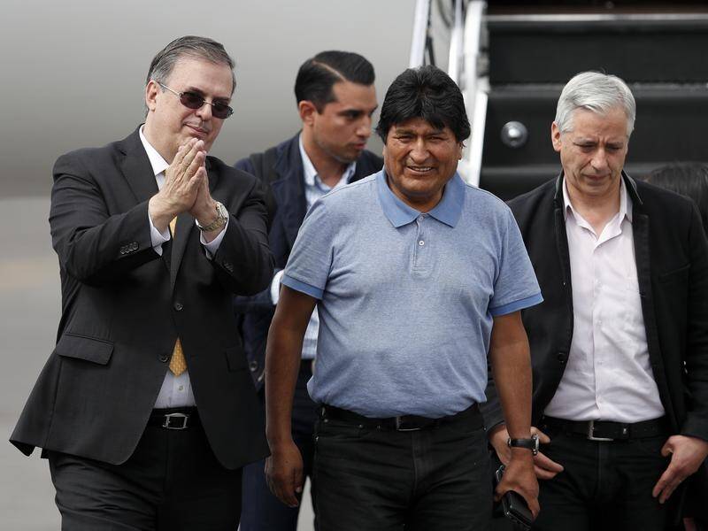 Bolivia's ex-president Evo Morales (C) has been met by Mexican Foreign Minister Marcelo Ebrard (L).