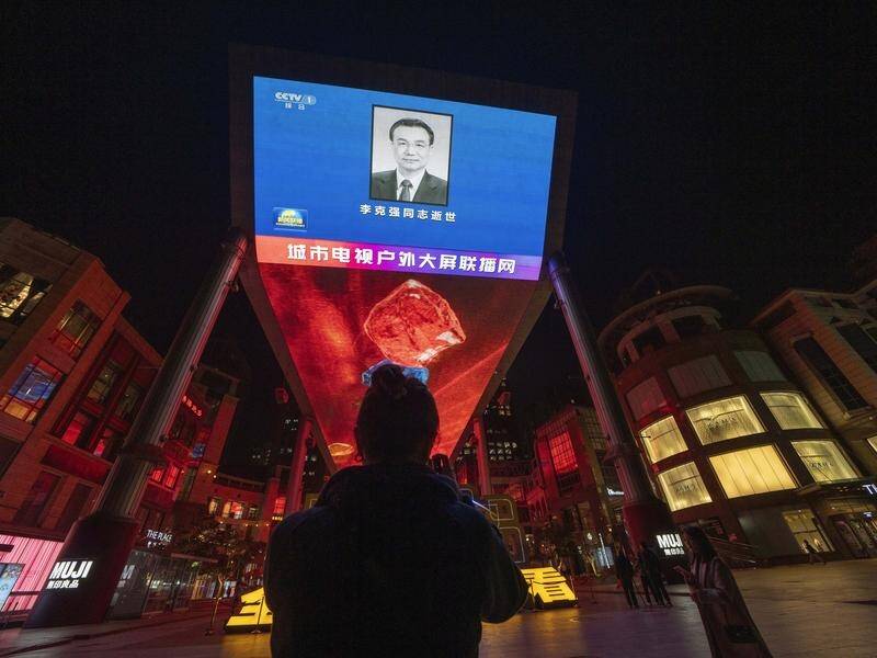An obituary photo of former Chinese premier Li Keqiang is shown on a giant screen in Beijing. (AP PHOTO)
