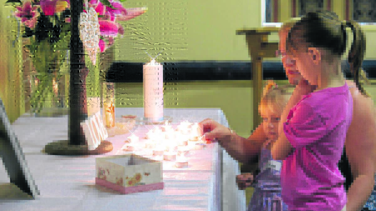 SOMBRE MOMENT: Families recently came 
together to reflect, remember, share and celebrate the brief lives of their precious babies.