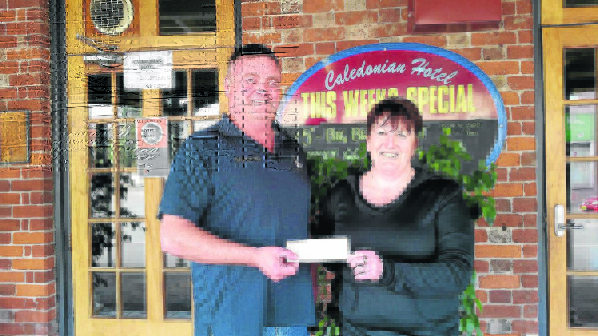 FUNDRAISER: Shane Hill presents a cheque to Ruth Rogers.