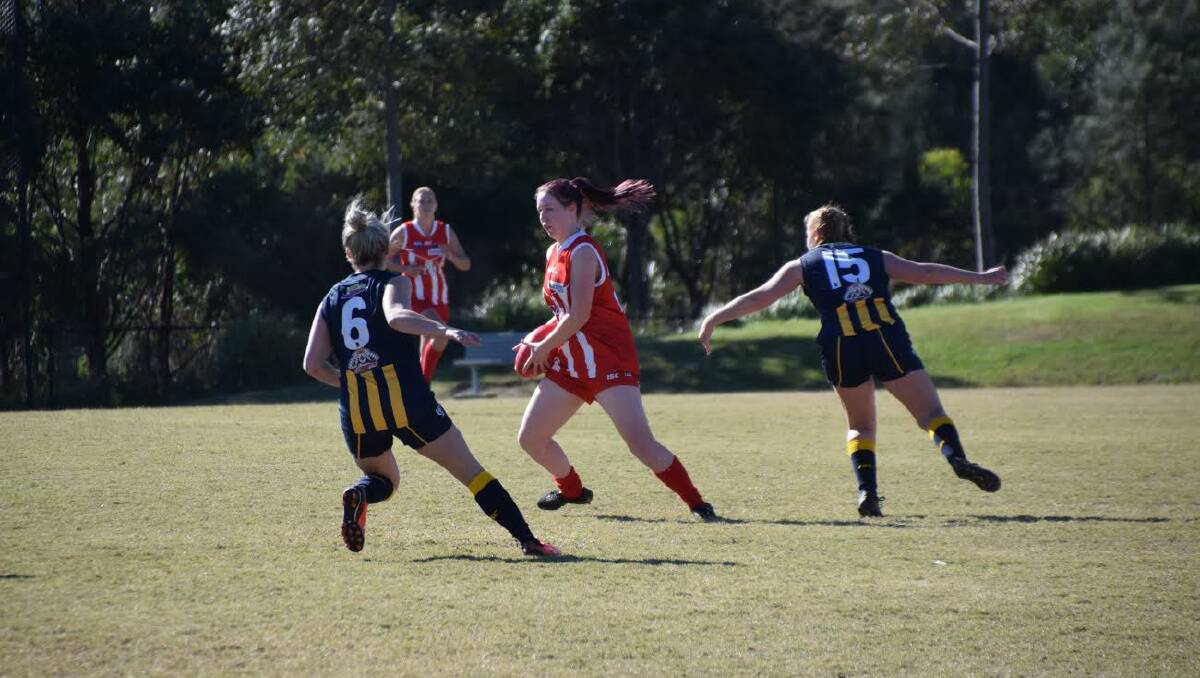 DEBUTANT: Brenna Edsell waltzes around her Bay opponents Bethany Allars and Sophie Fowler.