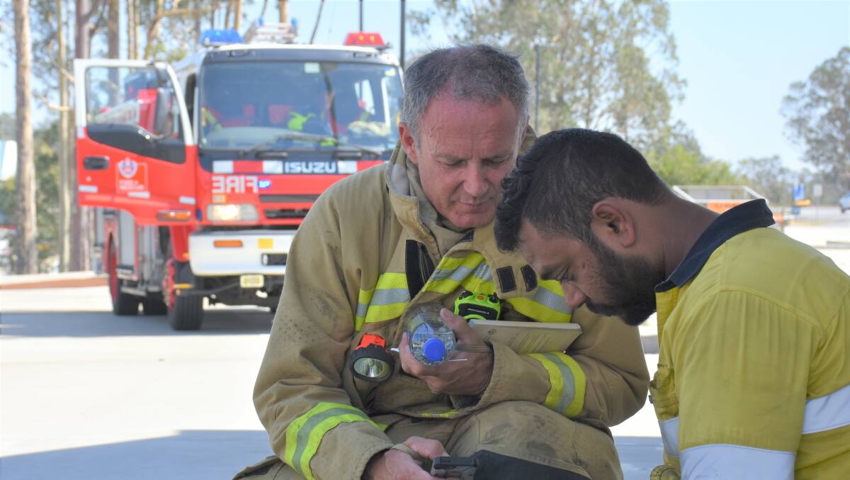 ACT OF BRAVERY: Singleton 444 Fire and Rescue team member Chris Taylor pictured with Sydney truck driver Navonkar Singh.