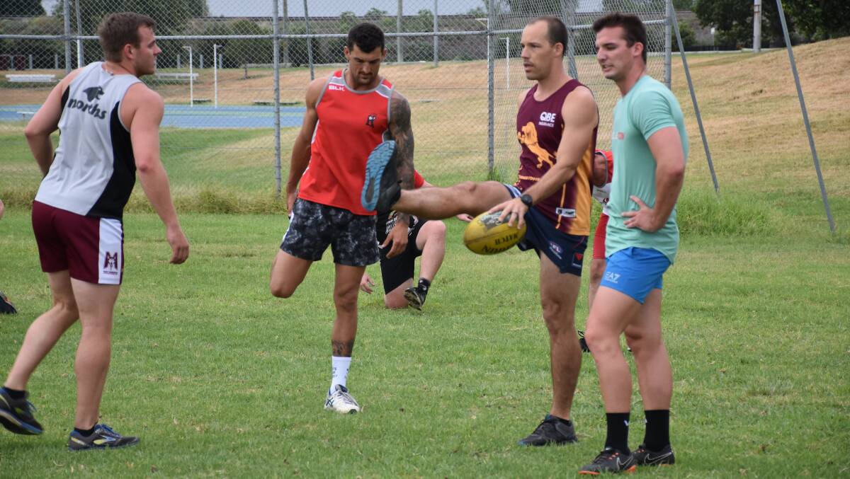 BACK TO WORK: The Singleton Roosters return to the training track under senior coach Andrew Scott (pictured holding a yellow football).