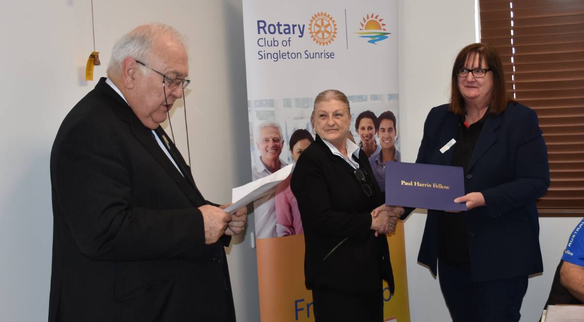 AWARD CEREMONY: Past president Karen Stout was recognised as a recipient of the Paul Harris Fellow award by Mr Gerard McMillan and current Rotary of Singleton Sunrise president Wendy Love.