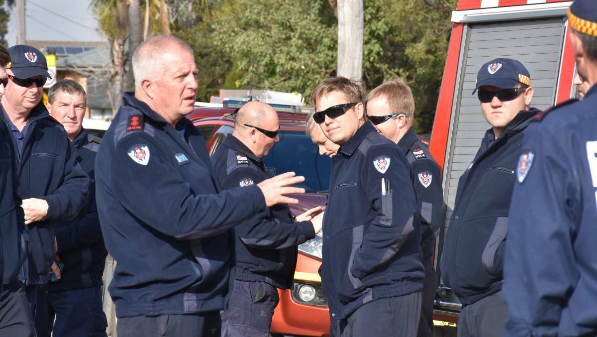 FRONTLINE: Bruce Ambrose addresses the members of the Singleton Fire and Rescue brigade who returned to the scene this morning.