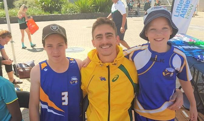 MEETING THE HERO: Lachlan Muddiman (Singleton Public School), Brandon Starc (Olympian and equal Australian record holder for High Jump) and Luca Santry (King Street Public School).