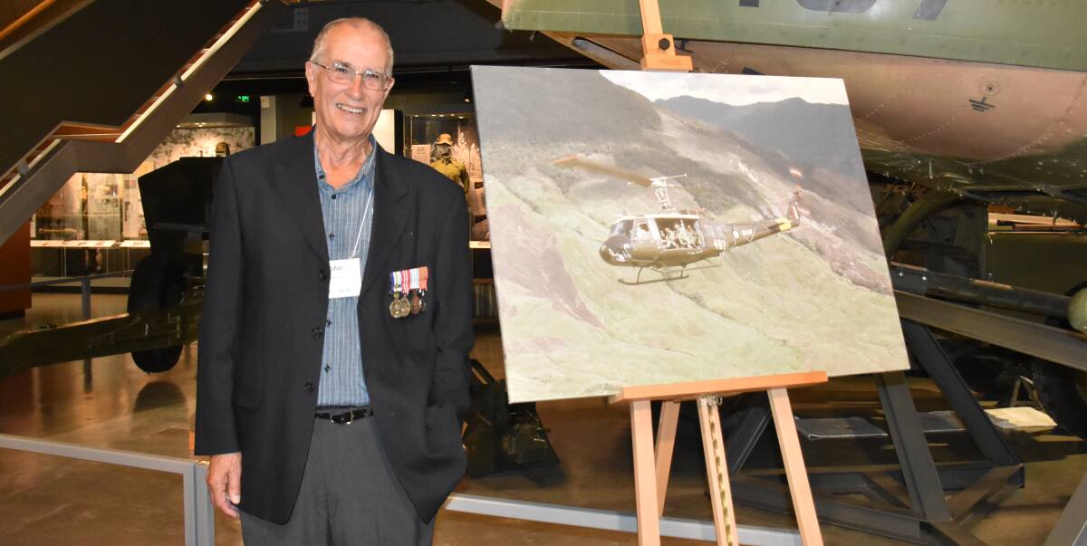 PROUD PHOTOGRAPHER: Serviceman John Humphrey pictured alongside the print of a photo he captured in Papua New Guinea circa September, 1971.