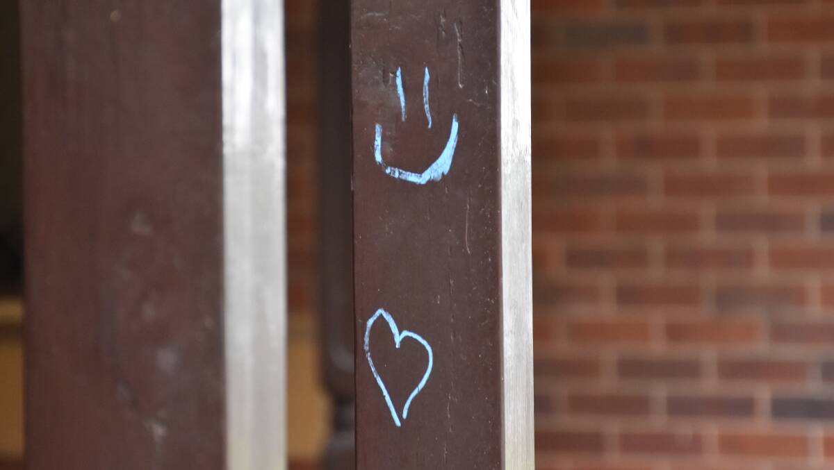 KEEP SMILING: The students spread positive messages across the porch of the Singleton Police Station on Wednesday afternoon.