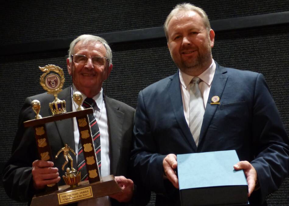 LEADING THE EXAMPLE: Michael Akrill hands the club person of the year award to Warren Gillespie at the Singleton Strikers' end of year presentation evening.