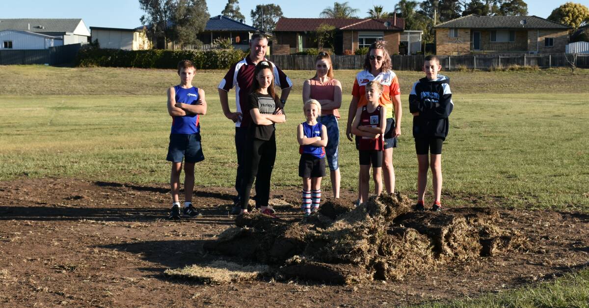 ENOUGH IS ENOUGH: Members of the Singleton Strikers (soccer) and Singleton Striders (athletics) gathered Alroy Oval this afternoon after new turf had been stolen from the ground just days after it was laid out.