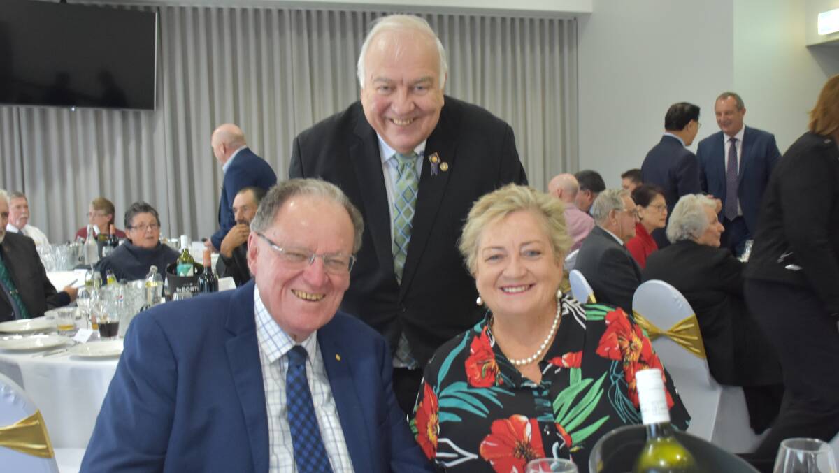 ALL TOGETHER: Singleton Diggers Club manager Gerard McMillan stands behind ClubsNSW chairman Peter Newell and his wife Judy. The couple had visited Singleton earlier this month in honour of McMillan's 40 years of service.