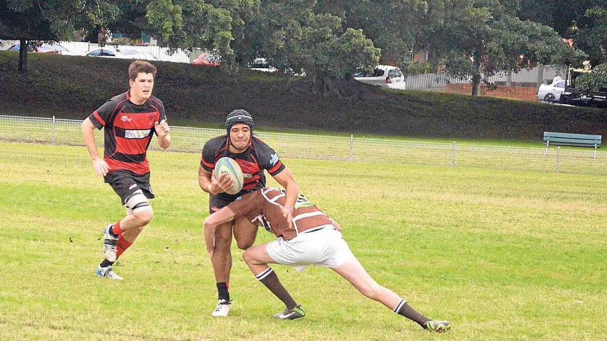 FLASHBACK: Former Bulls player Paula Kafohiva Moui takes the ball up against the Cooks Hill Brown Snakes with Dr Mitchell Tanner in support back in 2013.