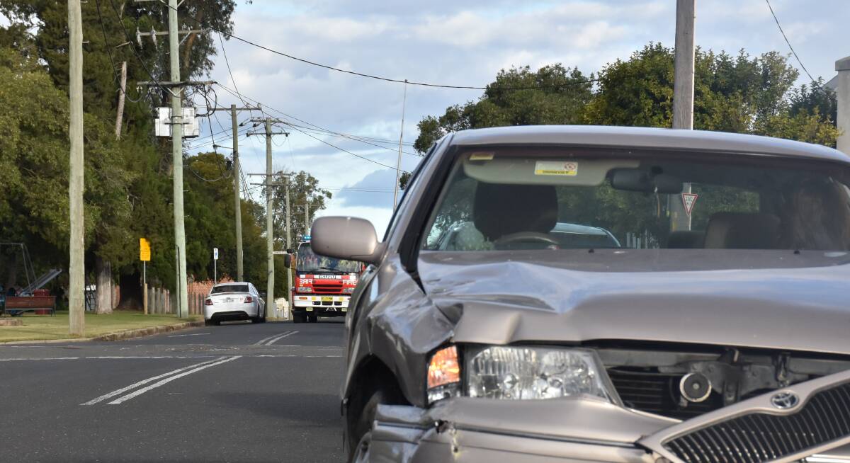 MOMENTS AFTER IMPACT: The first of two fire trucks is pictured driving towards the the intersection of Bourke and Elizabeth Street minutes after an elderly woman and her Toyota Avalon collided into a school bus. No children were present on the bus while both drivers escaped unscathed.