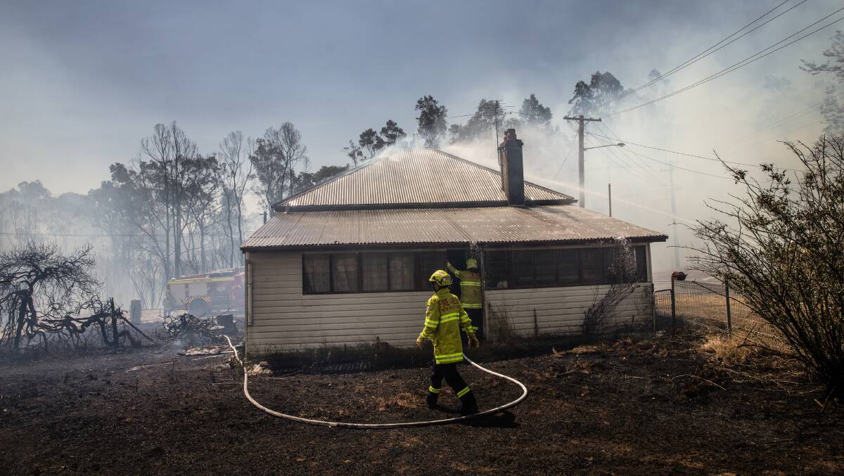 RESPONSE: Fire crews protect a property at North Rothbury earlier this month. Picture: Marina Neil