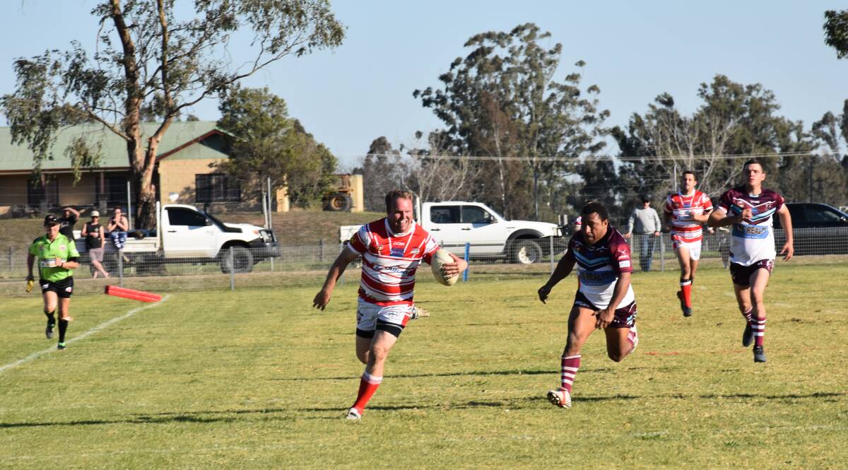 ALMOST: Luke Gardner pictured attempting a late try in his side's 84-0 first grade win over Denman.