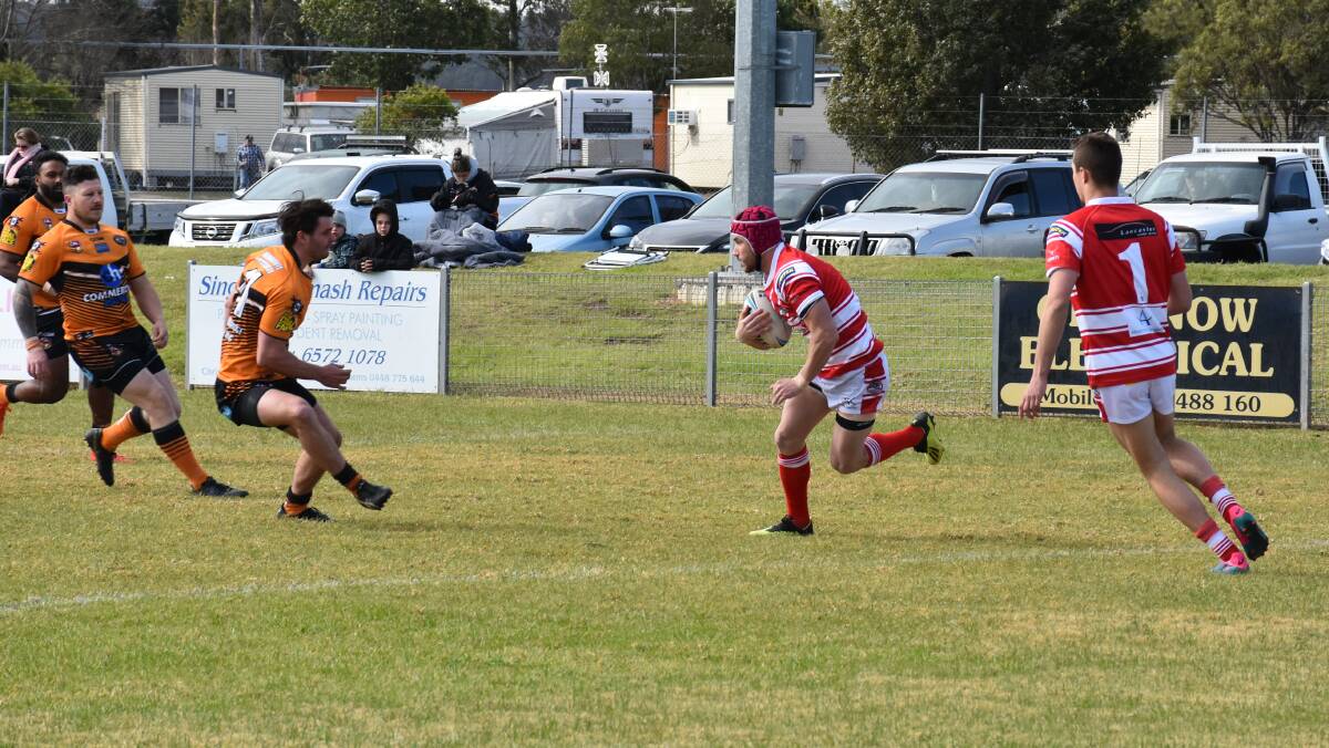 ON THE RUN: Singleton aims for an early try in the second grade match.