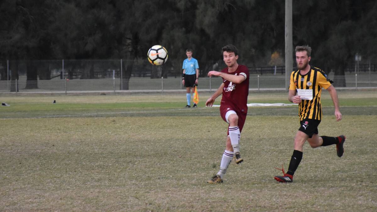 ANOTHER DERBY, ANOTHER DRAW: Singleton captain Hayden Nicol works the ball away from opponent Matthew Rees (Cessnock City Hornets). It was the second time the two sides played off in a 1-1 draw this season.