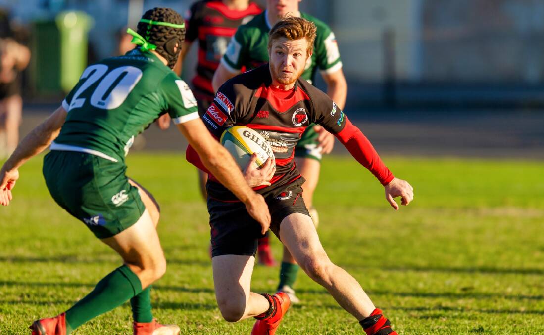 IN ACTION: Singleton Bull Lachlan Charnock in action against Merewether Carlton. (Photo supplied)