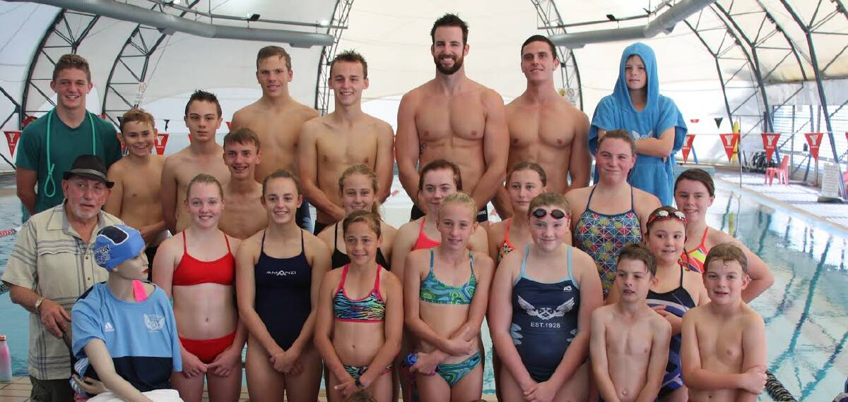TALENT: Dolly's Charity shop manager Gary Holland and local swimmers pictured with visiting stars James Magnussen and Kurt Herzog.