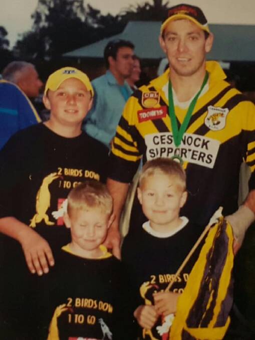 FROM THE ARCHIVES: Connor Kirkwood (bottom left) with brother Liam, friend Michael and uncle Luke Thomas moments after the Goannas 22-20 grand final victory over Raymond Terrace in 2003.