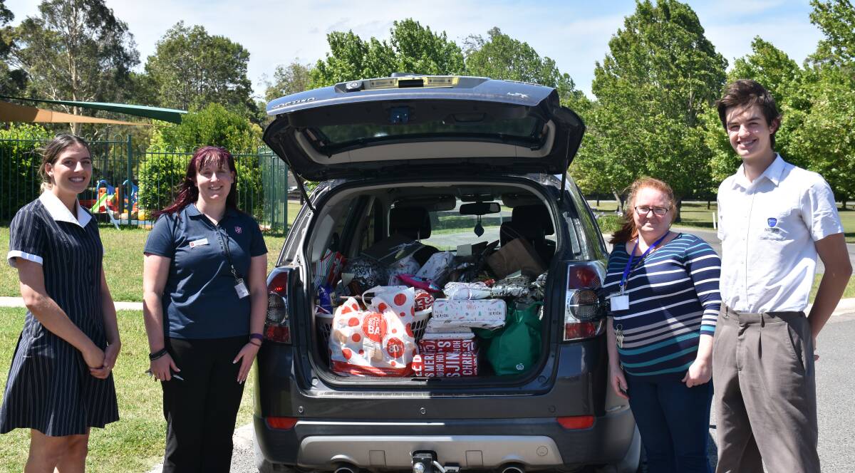 CAR LOAD: Special guests Emma Parrey (Welfare Youth Minister) and Marie Loftus (Family Store Manager) of the Salvation Army with students.