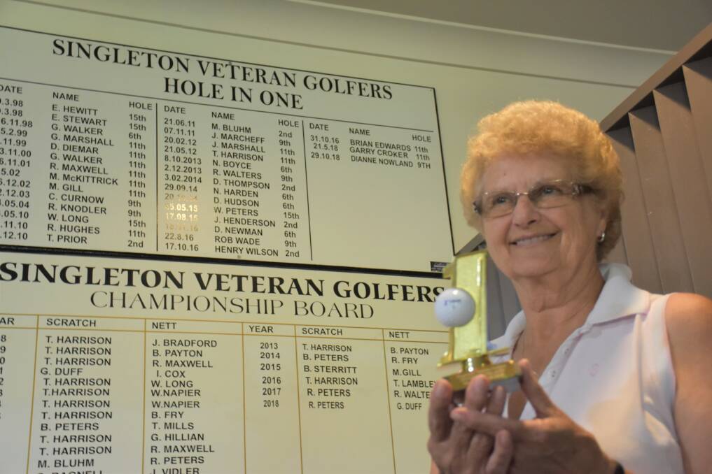 PROUD HONOUR: Dianne Nowland receives a trophy for her hole-in-one at the Singleton Golf Club.