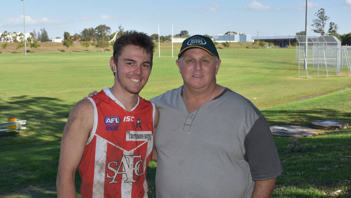 WELCOME TO SENIOR FOOTBALL: Luke Draper (pictured with his father Mal) was named in the Roosters' best players.