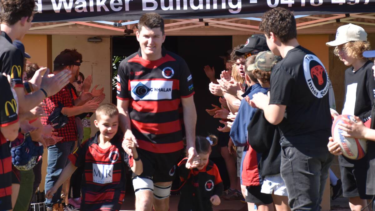 MILESTONE MAN: Dr Mitchell Tanner leads his side out for game 300 in a senior career which dates back to 2003.