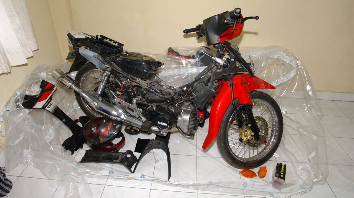 This motorbike was seized and belonged to a suspect. The AFP's fingerprint team made a makeshift cyanoacrylate chamber to develop latent fingerprints to identify the suspect. Picture by AFP