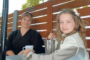 SMOKE-FREE: Louisa Hurney enjoys a coffee and daughter Eliza, 8, has a milkshake in the smoke-free outdoor area of Singleton’s One-O-One Coffee House.