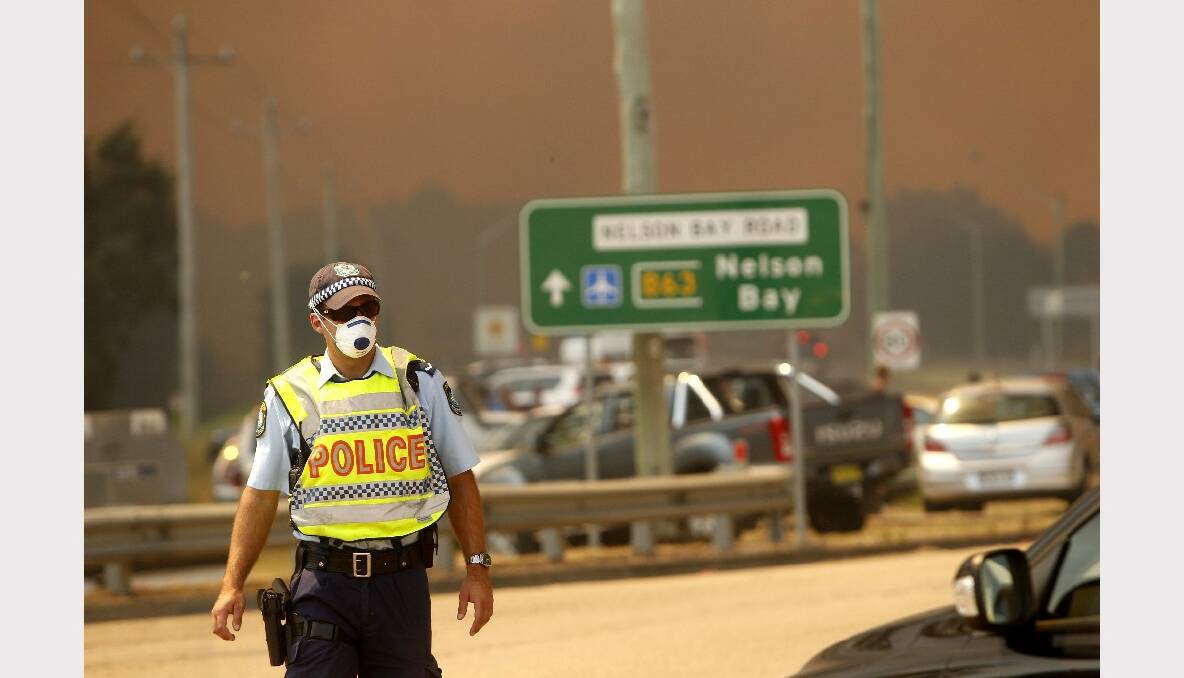 A fire has broken containment lines at Williamtown. Pictures taken from corner of Cabbage Tree Road and Nelson Bay Road. Photo: Jonathan Carroll, Newcastle Herald.